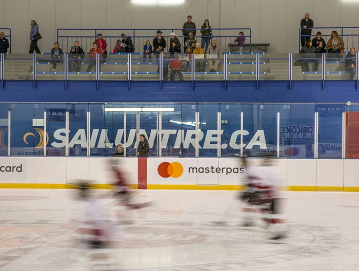 Hockey rink with branded rink board advertising in a Canadian community arena