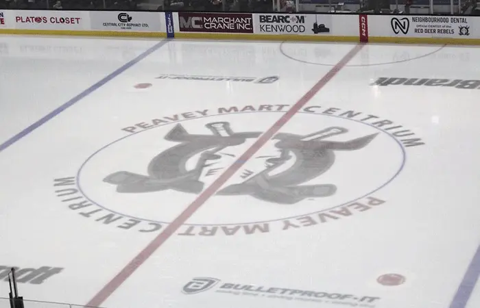 Hockey rink with branded rink board advertising in a Canadian community arena