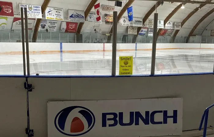 Hockey rink with branded rink board advertising in a Canadian community arena
