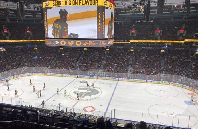 Hockey rink with branded rink board advertising in a Canadian community arena