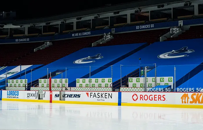 Hockey rink with branded rink board advertising in a Canadian community arena